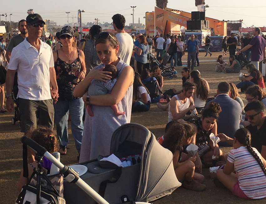Mutter mit Baby und Kinderwagen beim Public Viewing des European Song Contest in Tel Aviv